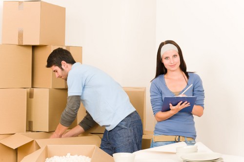 Moving boxes and furniture in a Watford home relocation scene